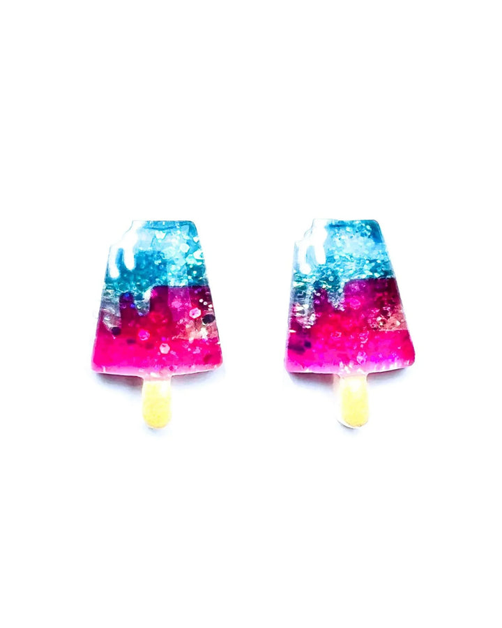 Glitter ice cream earrings with pink, blue, and yellow resin charms on white background