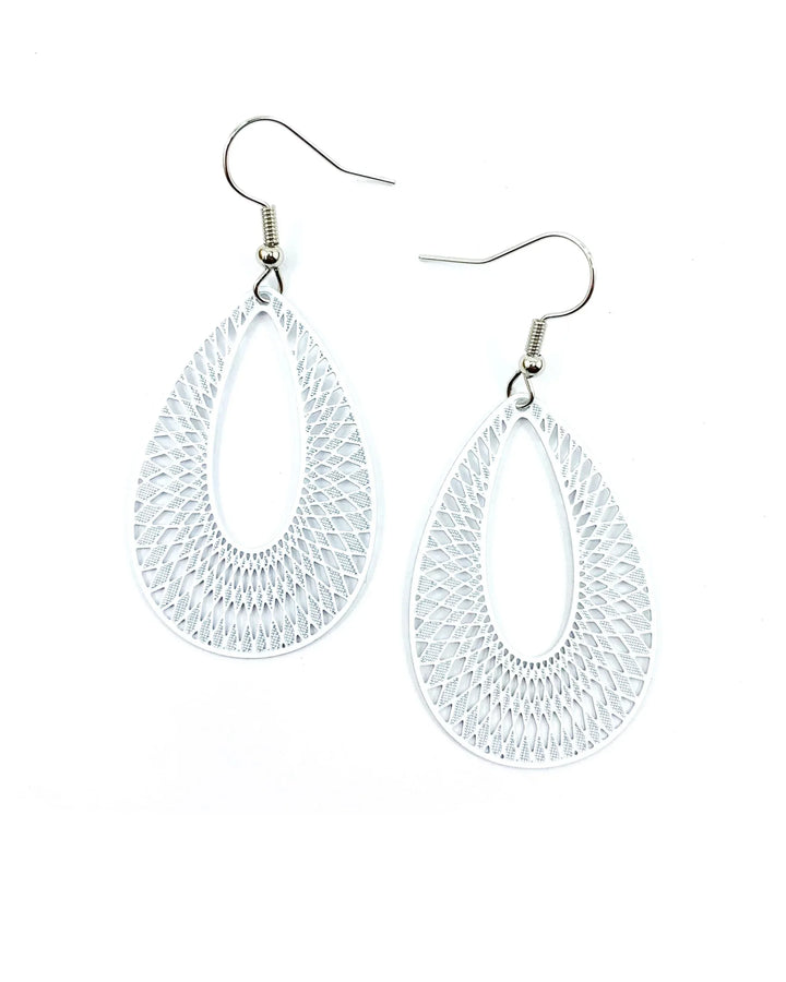 White lace-cut teardrop dangle earrings with detailed cut-out pattern and silver hooks