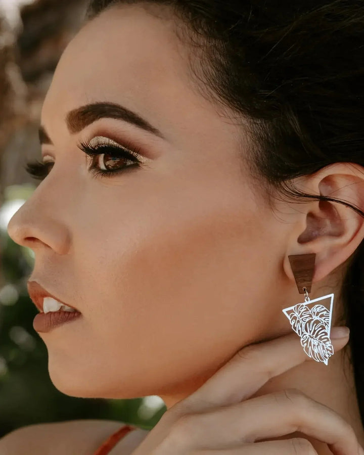 Timber and metal monstera leaf statement earrings on model