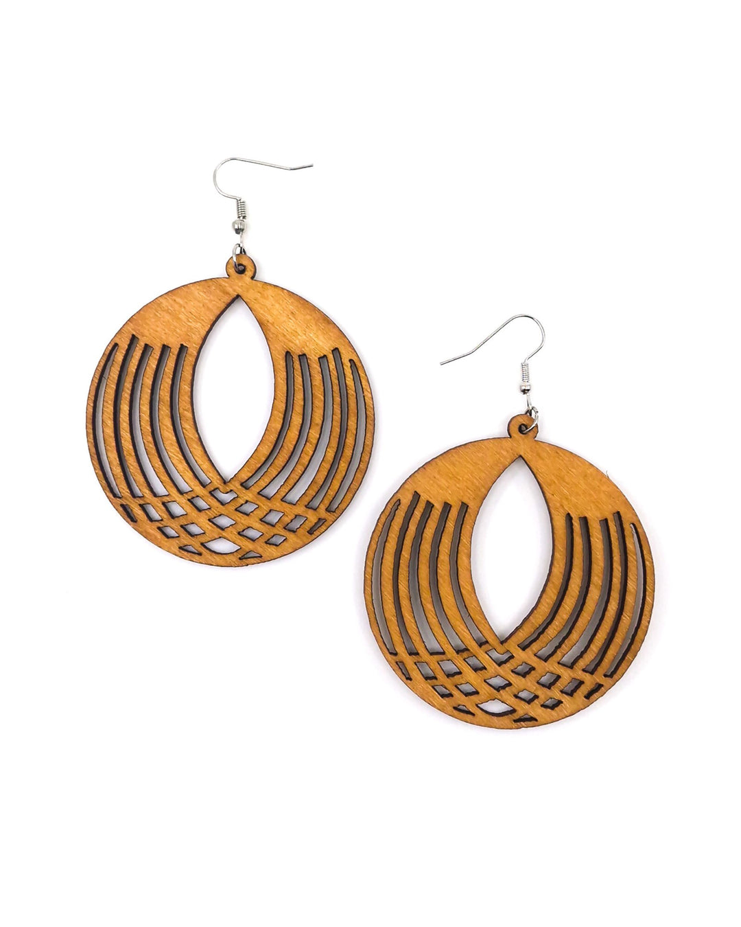 Close-up of round timber earrings showing curved geometric cut-out detail