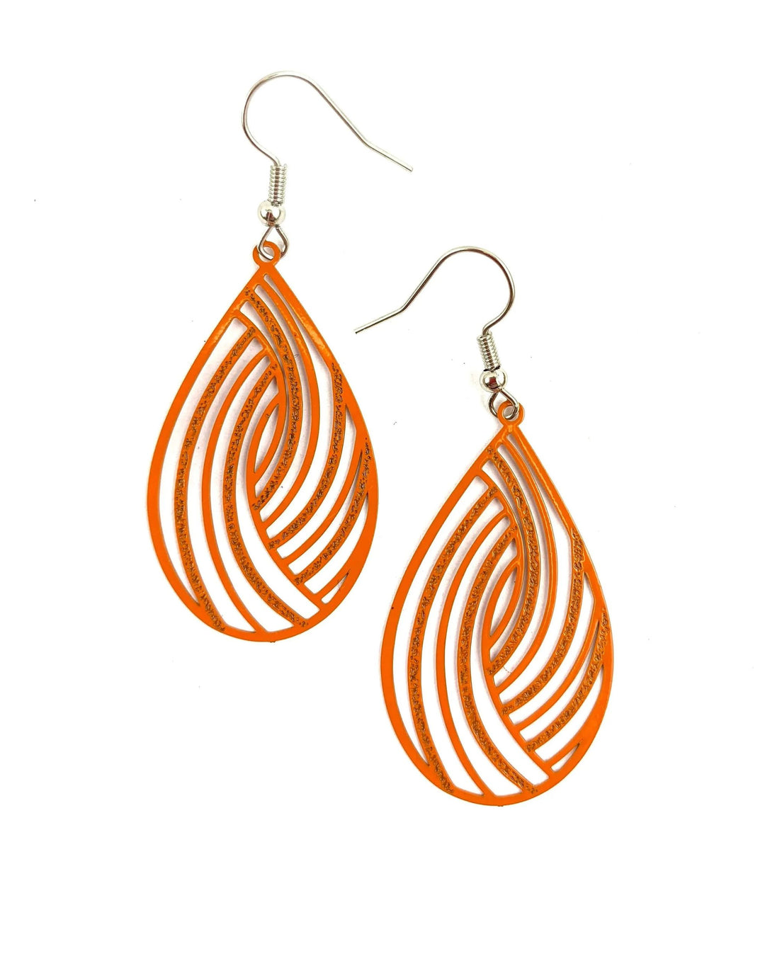 Pair of orange swirl cut-out teardrop dangle earrings with curved cut-out pattern and silver hooks
