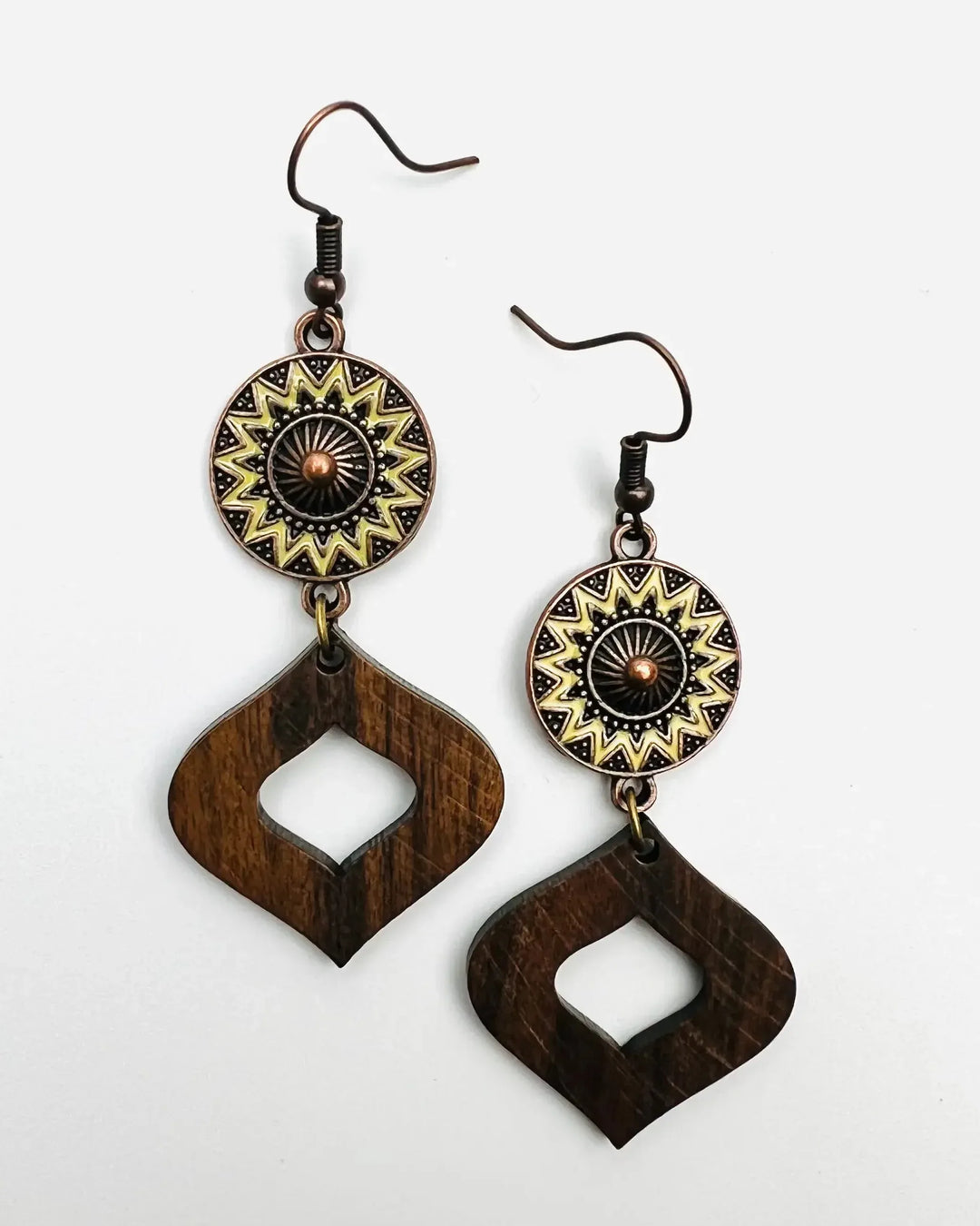 Close-up of timber and copper sun earrings showing brass sun charm and polished wood drop