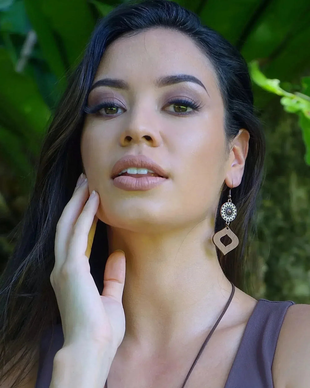 Model wearing timber and copper sun charm drop earrings with diamond shaped wood pendant