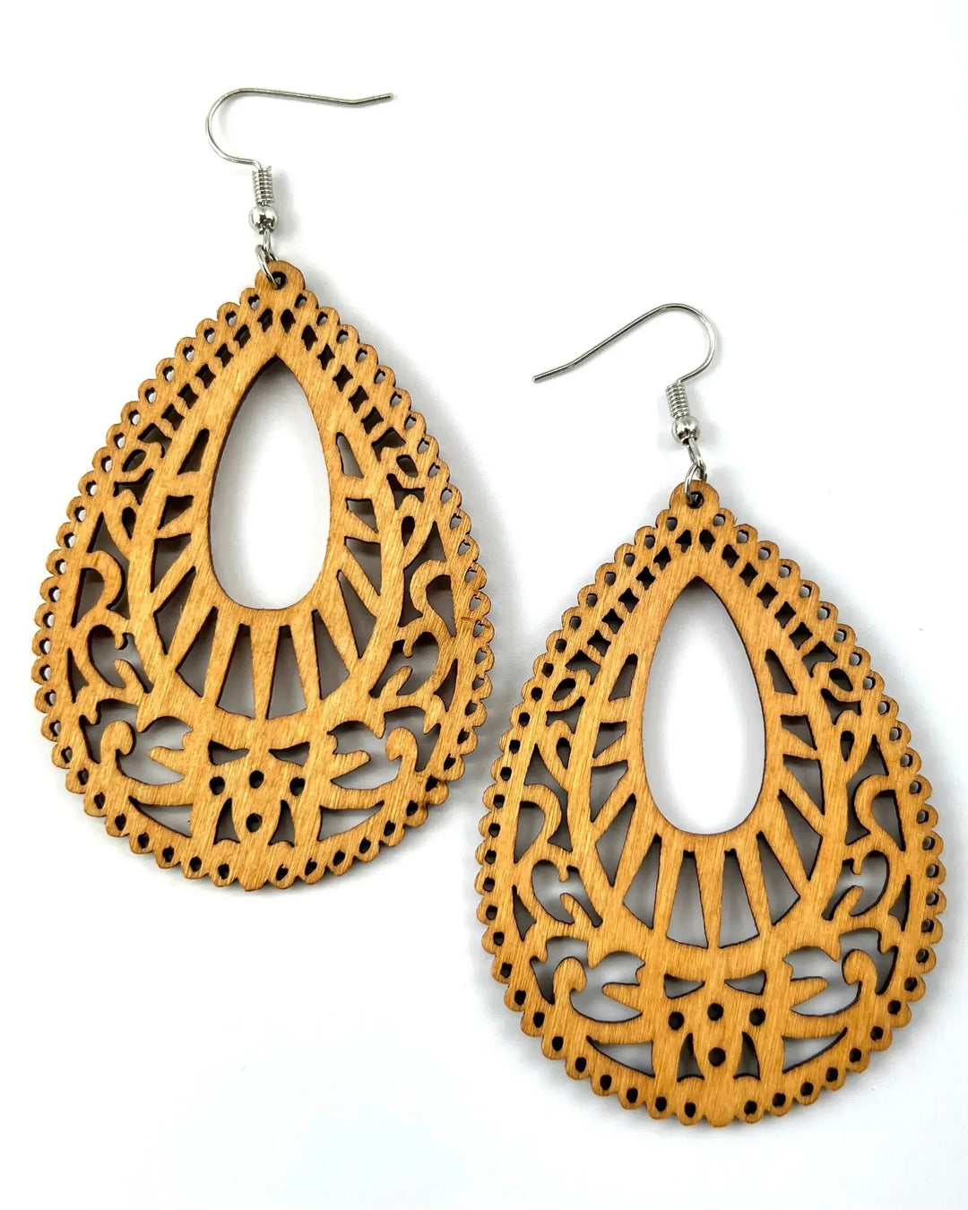 Boho timber earrings featuring a large teardrop shape with intricate floral laser-cut carvings in a warm honey wood tone.