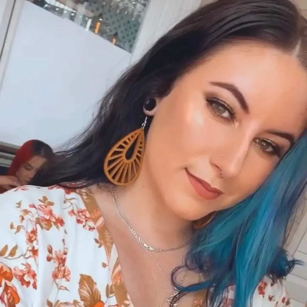 Model wearing large honey timber teardrop statement earrings