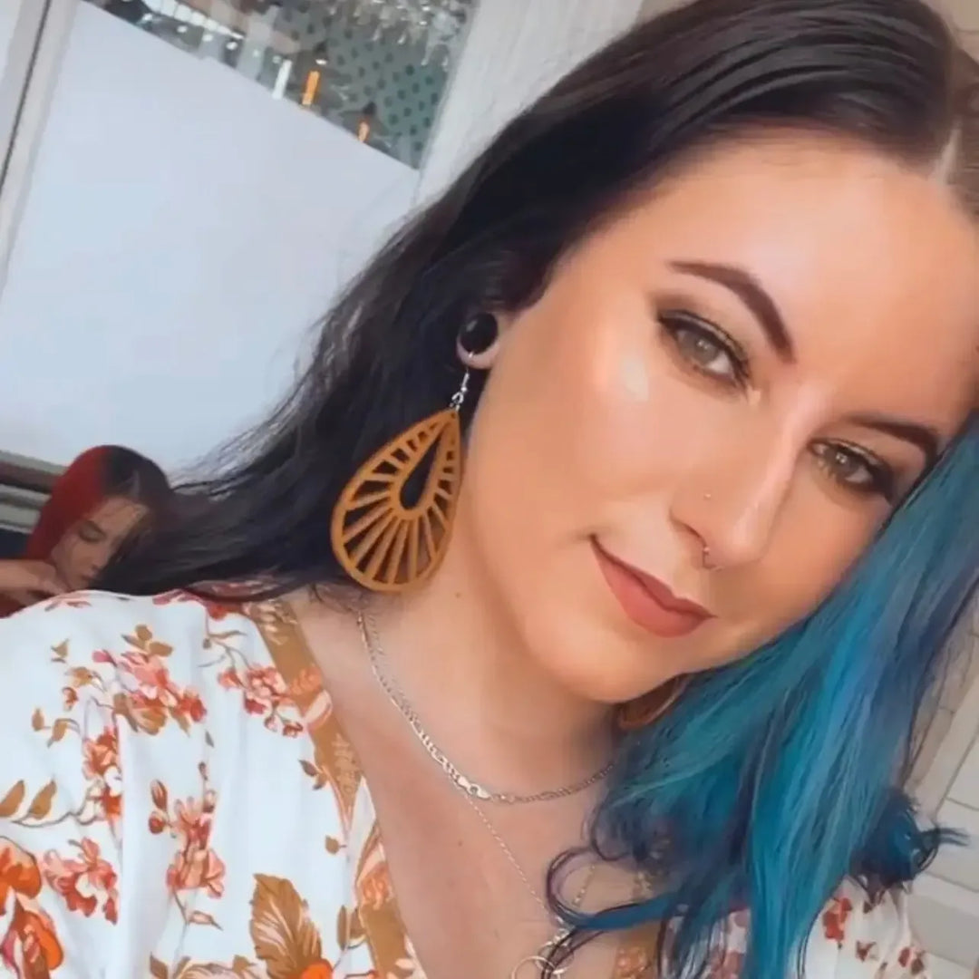 Model wearing large honey timber teardrop statement earrings